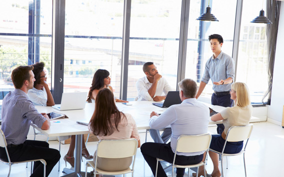 Businessman presenting to colleagues at a meeting